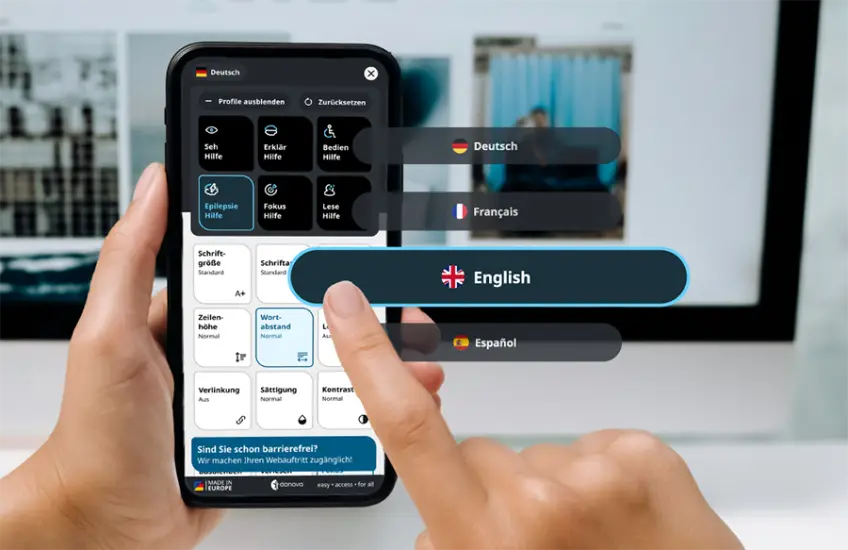 Eine Hand, die ein Smartphone hält. Der Finger tippt auf den Button "English". 